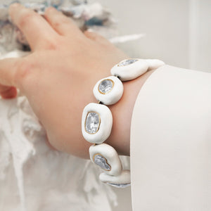 Bracelet & Bangle | Jingyayi | female wrist wearing an elegant handmade organic shaped ten-stone Moissanite white enamel bracelet.