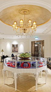 Jingyayi's main shop space displaying handmade art jewels in a high-end well decorated environment. 