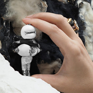 Meet Q-mi; an extra-terrestrial visitor from a galaxy far, far away. She has come to this planet on her cloud-shaped spacecraft in search of the most precious materials on earth.  Photo of the creator holding jeweled figure of "Q-mi" by www.jingyayi.com