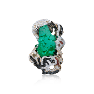 Hand-crafted uncut natural Columbian emerald showcasing its naturally vibrant green color that is striking against the black and white diamonds. Accompanied by white jadeite stones, this sparkling ensemble is encrusted onto the enamel and solid white gold base. by Jingyayi